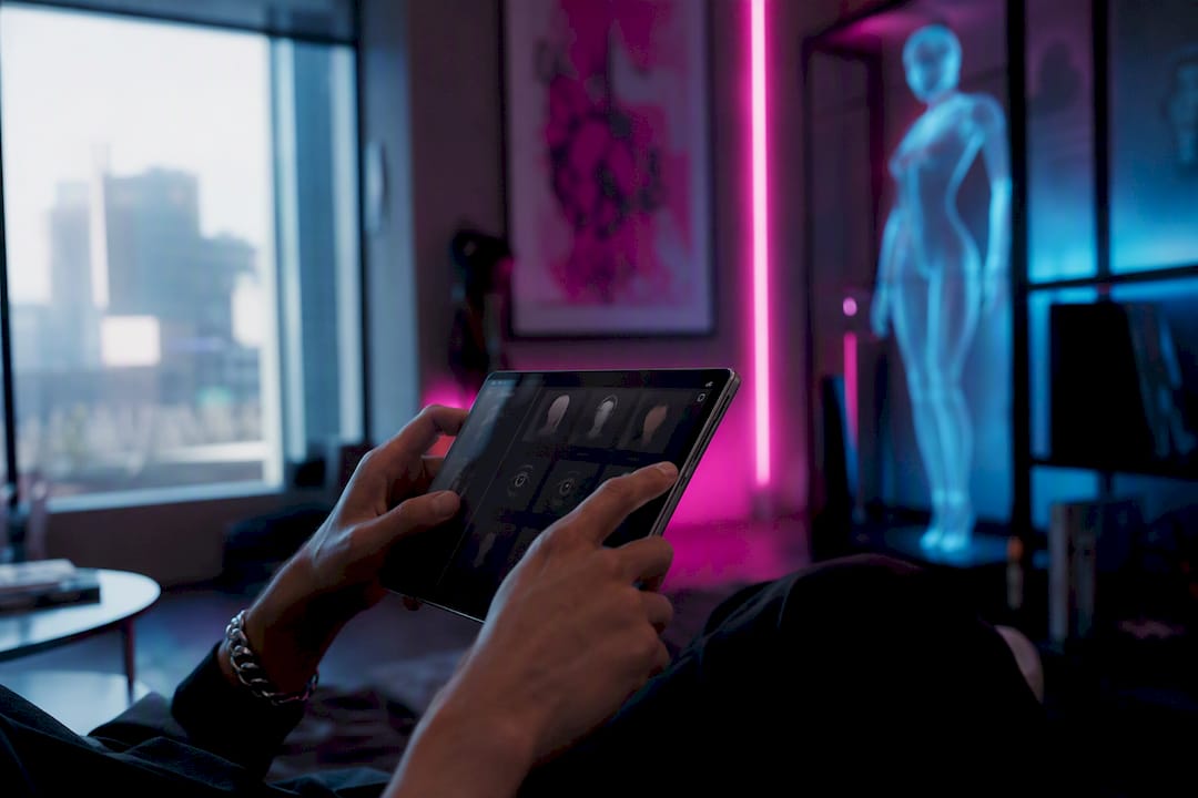 Hands holding phone in neon-lit cyberpunk room