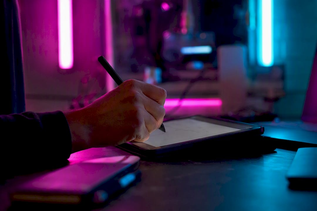 Cyberpunk desk with hand using stylus near phone