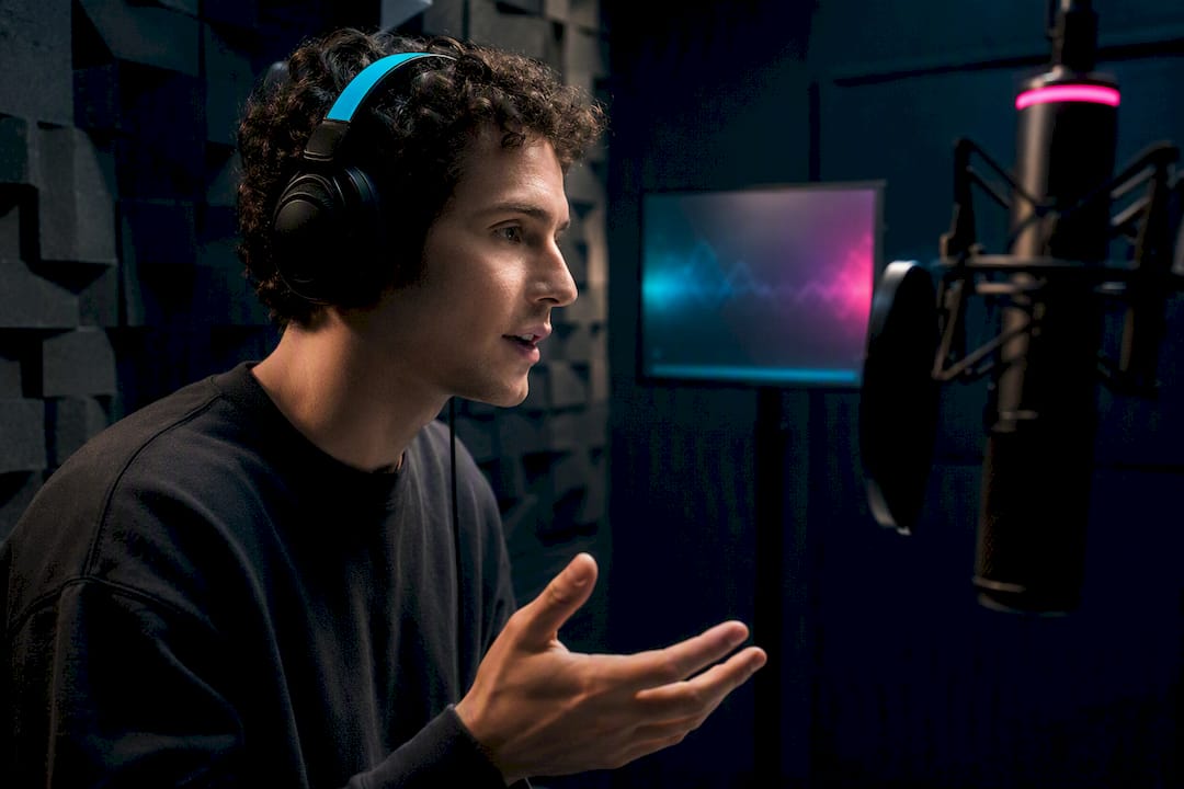 Person recording a voice sample in booth