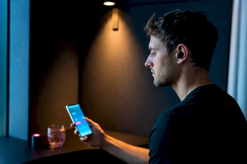 5 Quick Demo Tests to Judge AI Companion Voice Messages and Privacy Person listening to an AI voice message