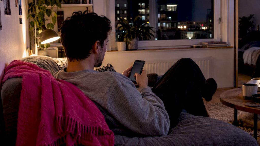 Long Distance AI Companion: Try a 7 Day Routine for Quiet Hours Person messaging an AI companion at night